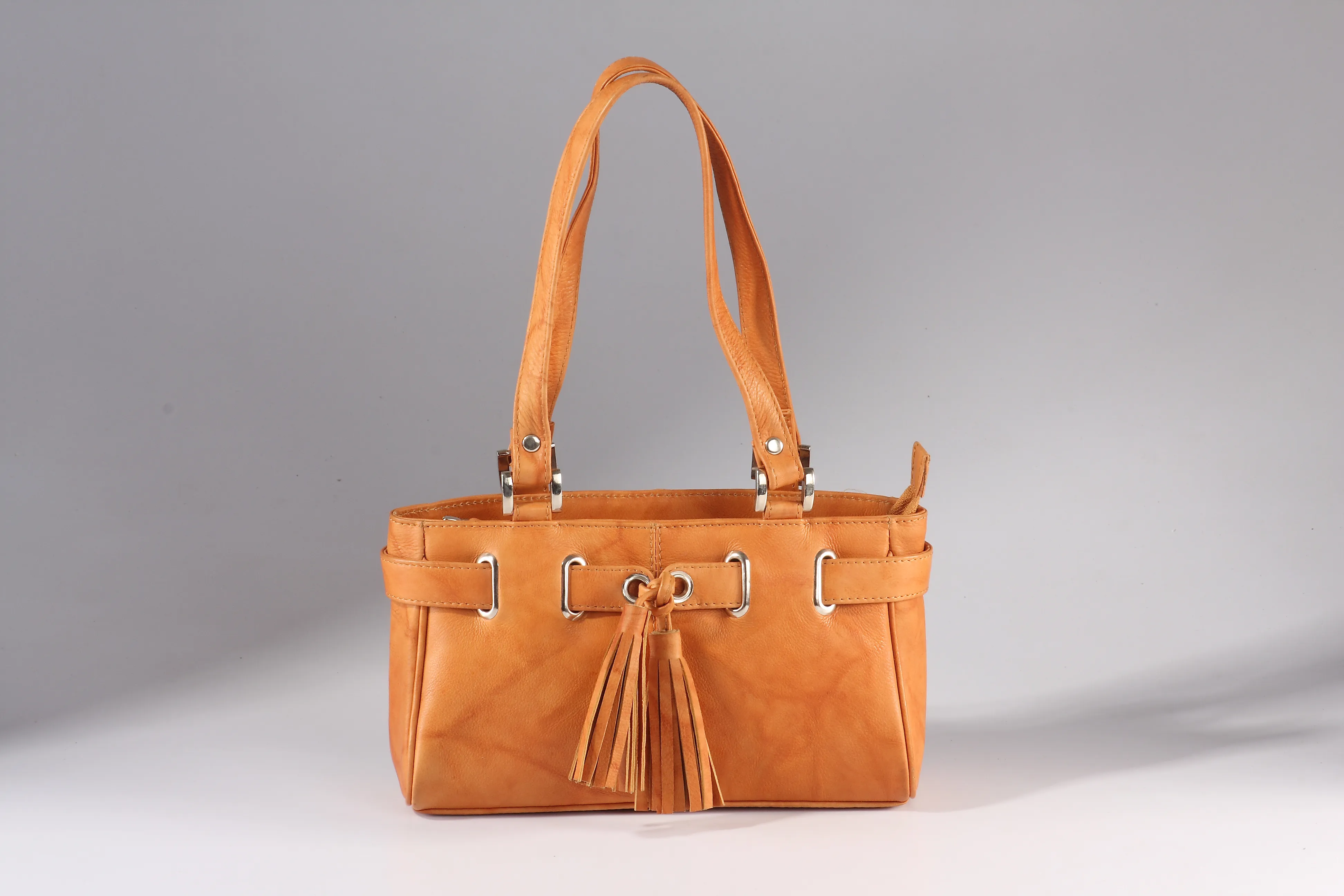 Antique leather handbag with optional external sling attachment, zip partition, inside zip pocket, back zip pocket, and mobile case. Compact and versatile design.