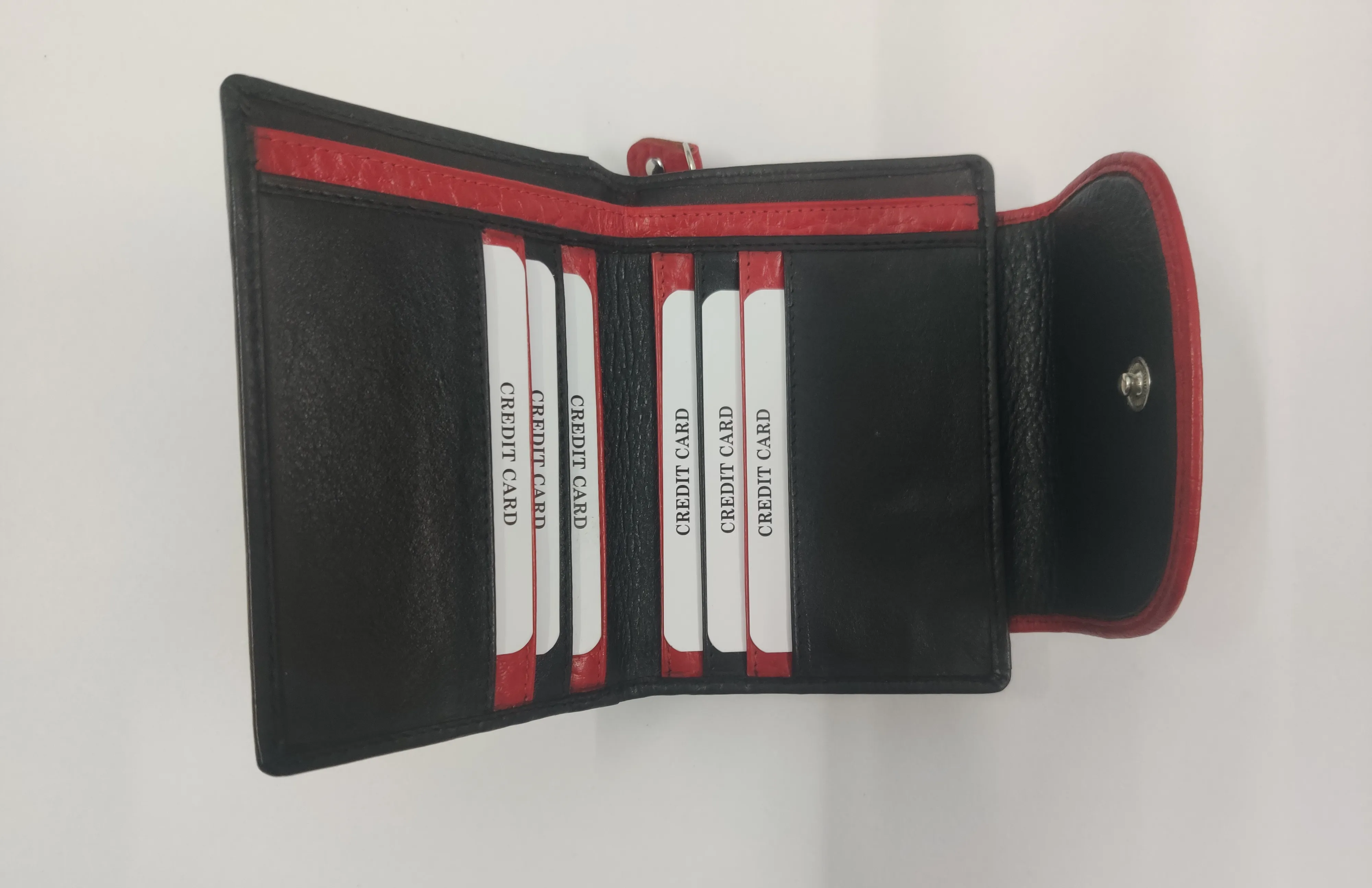 Red and black genuine leather purse with white thread detailing, multiple compartments, and a secure button and zipper closure.