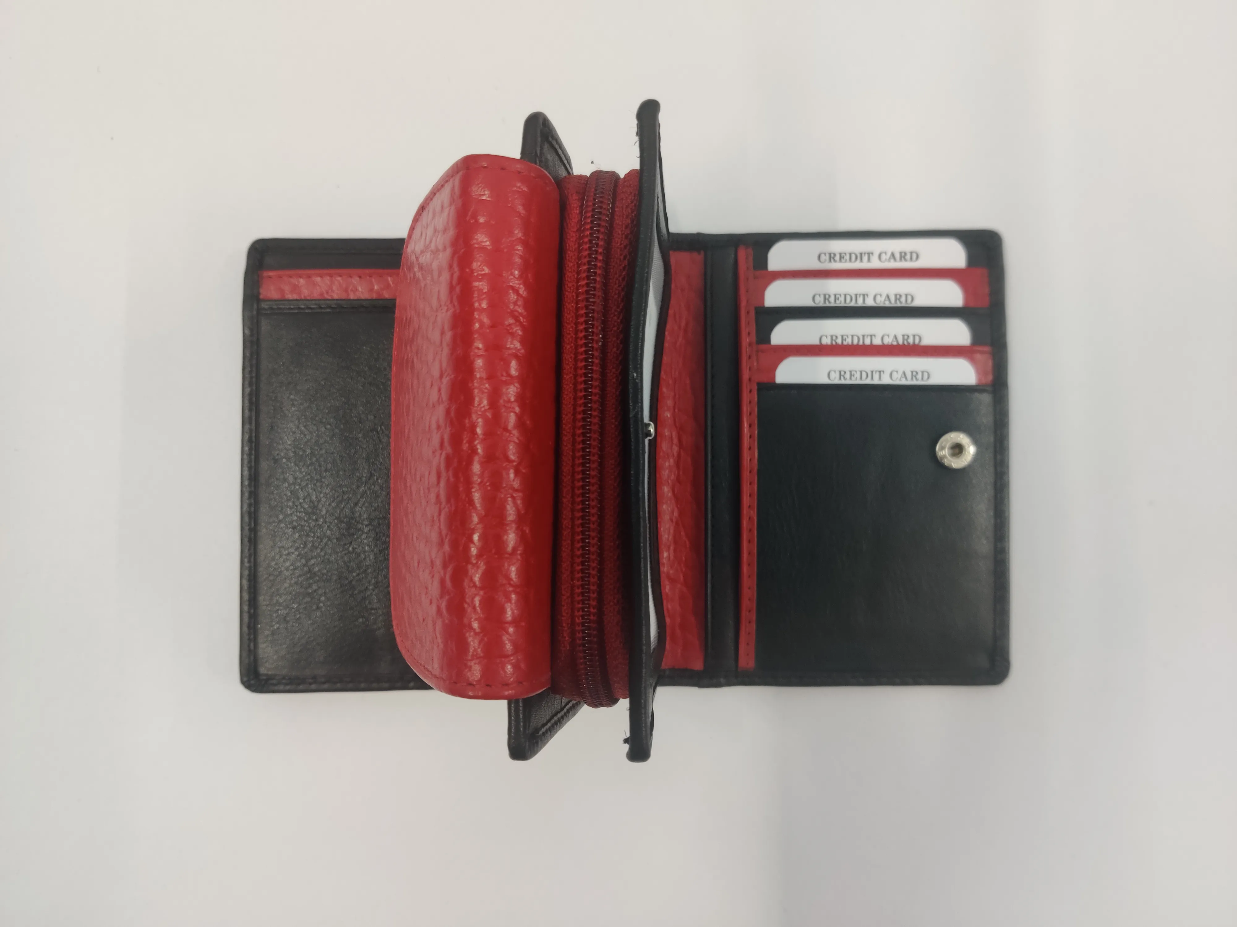Red and black genuine leather purse with white thread detailing, multiple compartments, and a secure button and zipper closure.