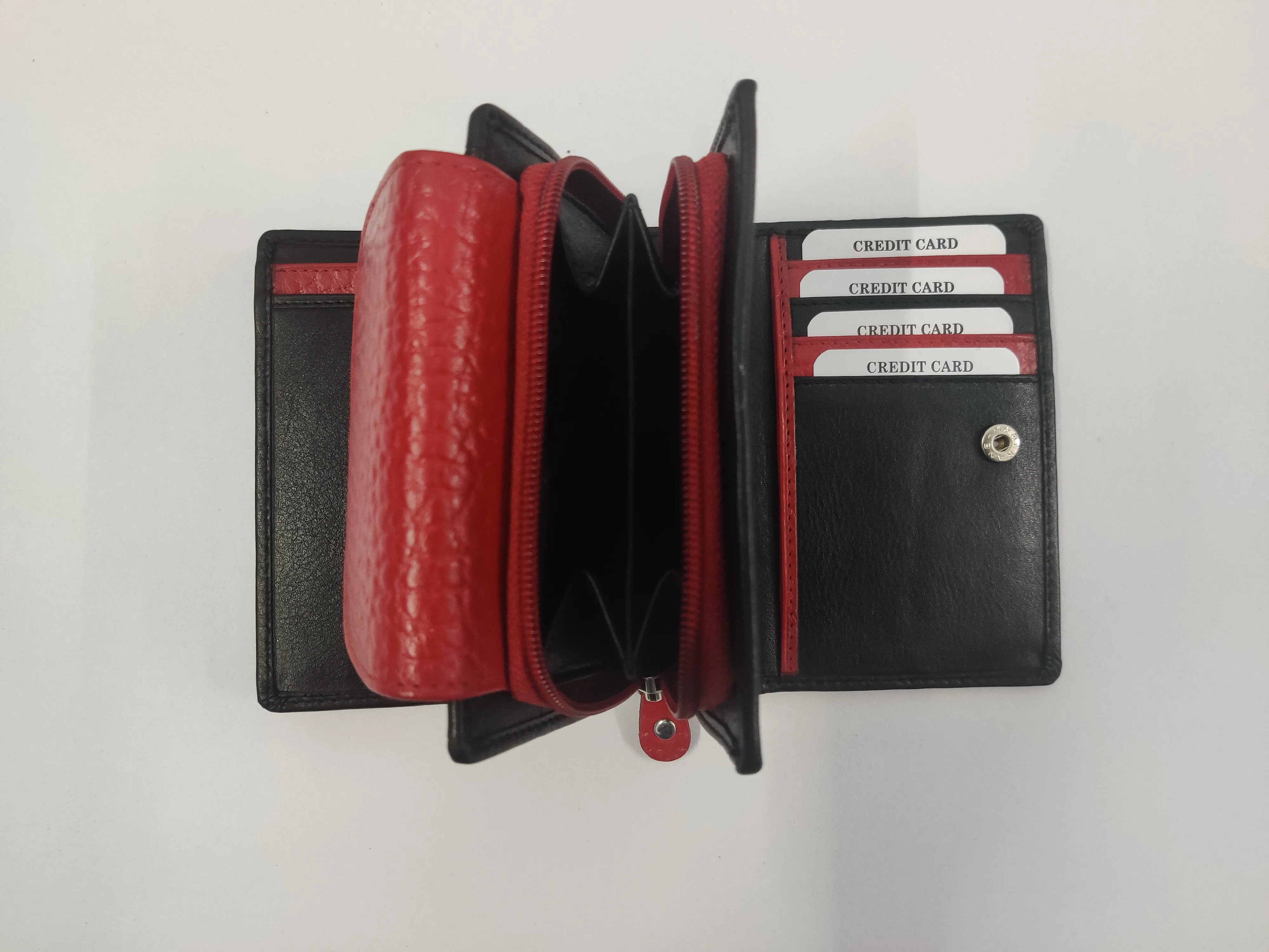 Red and black  genuine leather purse with white thread detailing, multiple compartments, and a secure button and zipper closure.