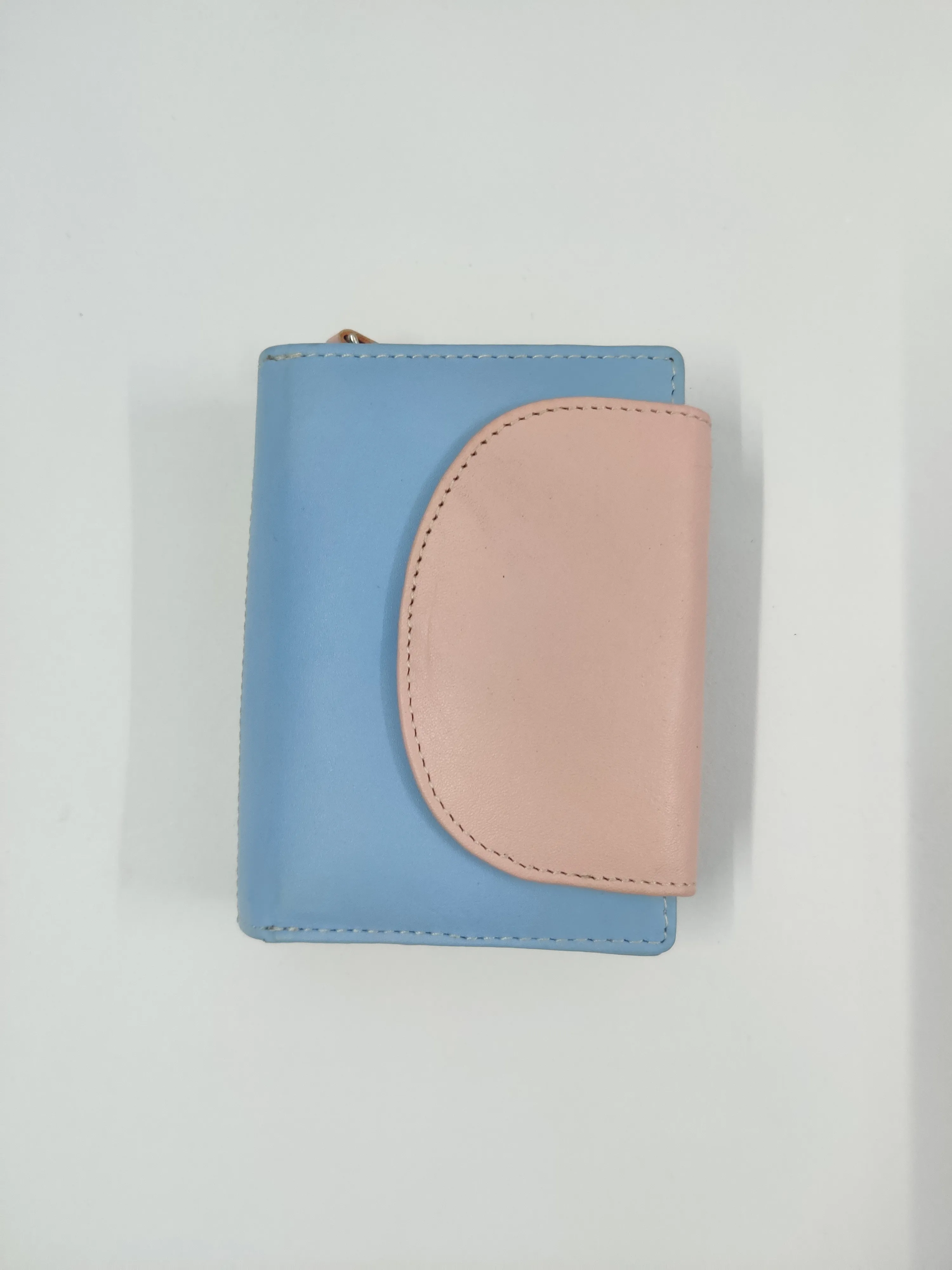 Multi-coloured genuine leather purse with white thread detailing, multiple compartments, and a secure button and zipper closure.