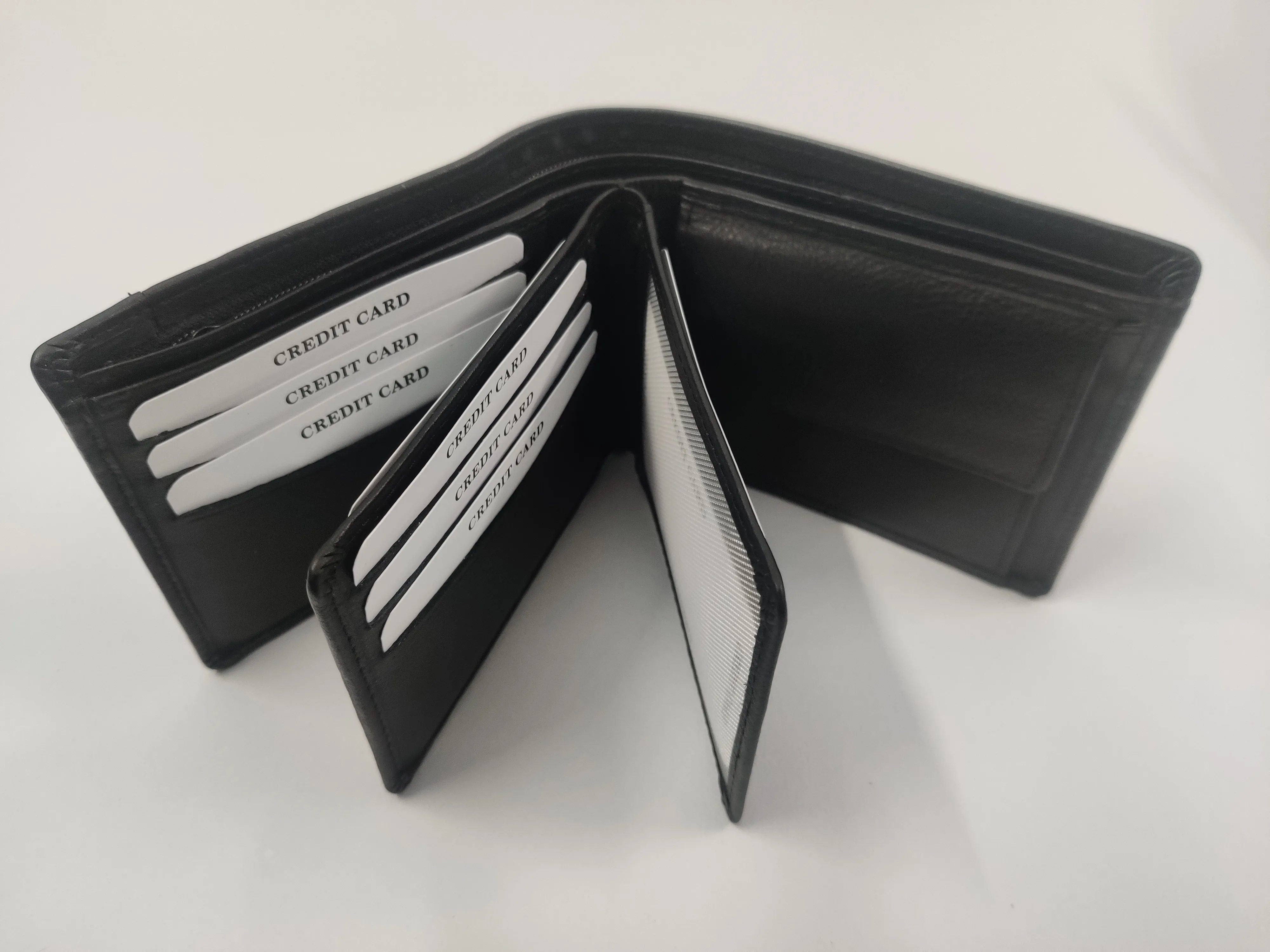 Genuine black leather bifold wallet with crescent card slots, RFID protection, dual ID windows, zippered compartment, and coin pocket.